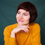 smiling mature brunette woman looking away playful and defiant close up face